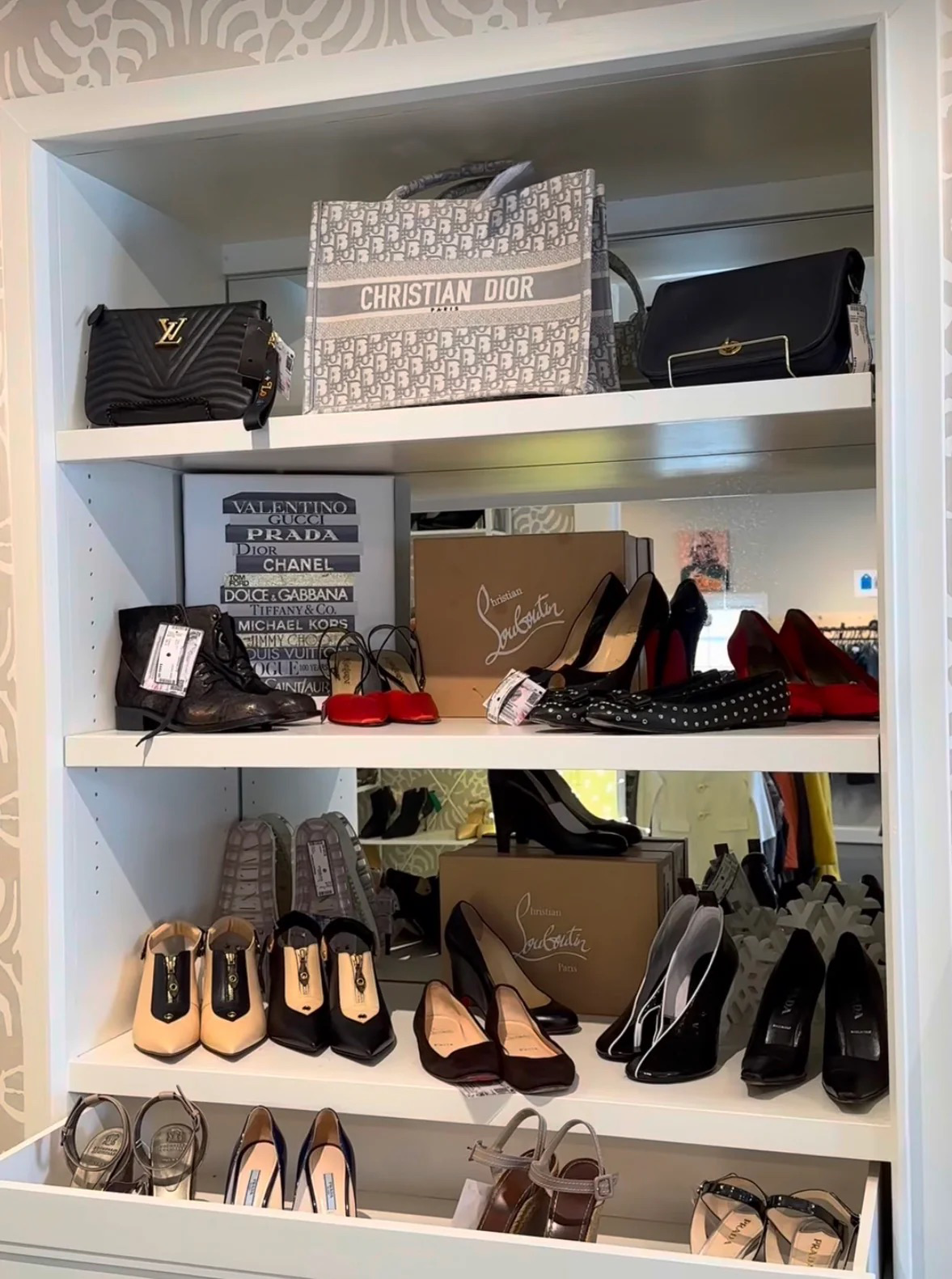 Shelves displaying various high-end handbags and shoes with brand names.